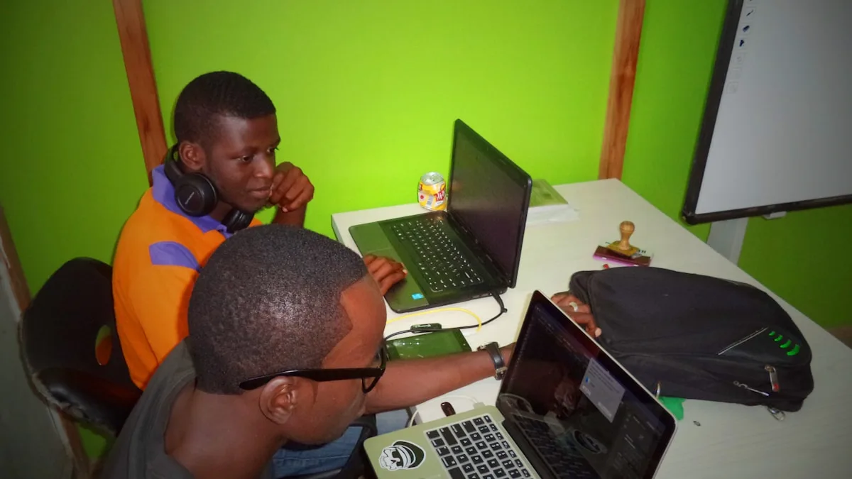 Two people collaborating and learning together using laptop computers